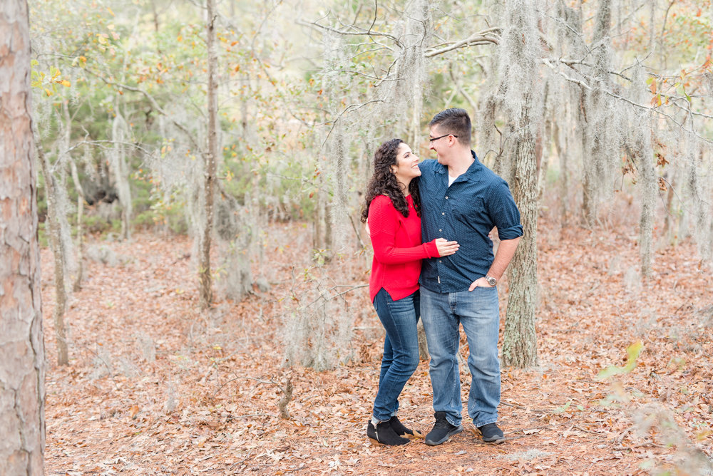  Engaged couple surrounded by Spanish moss for their fall engagement photos at First Landing State Park in Virginia Beach. 