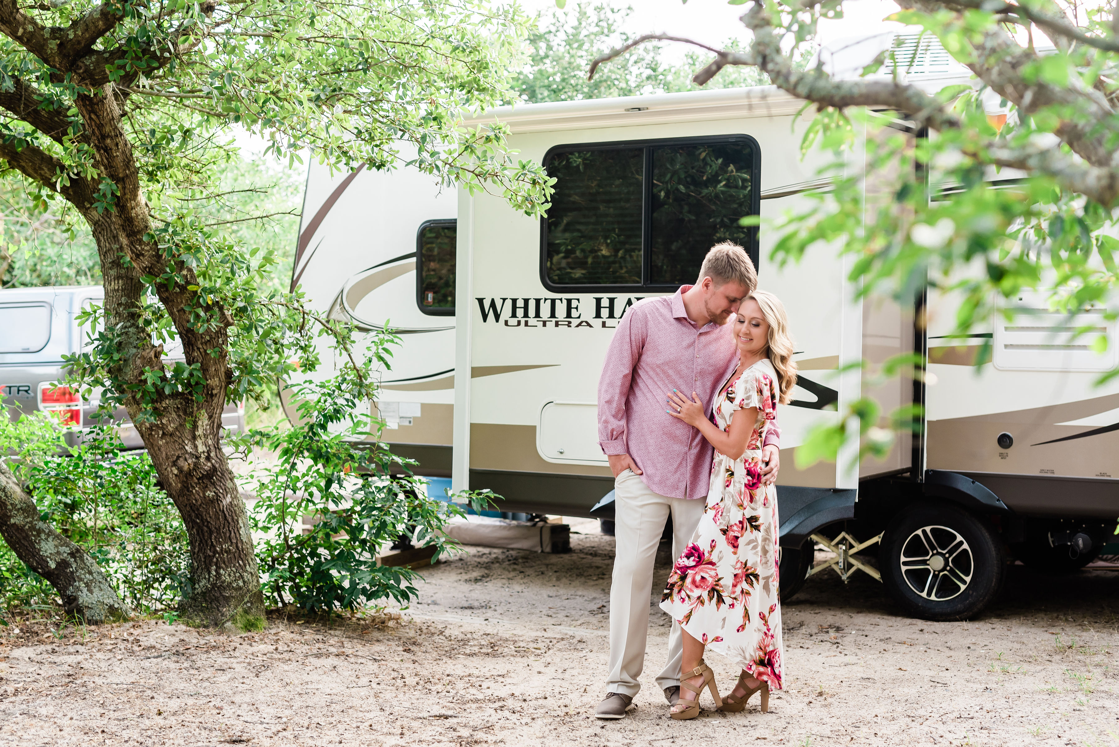Engaged couple with their camper